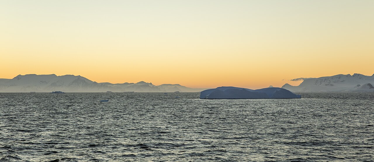 Sunset light over icebergs and mountains in the Gerlache Strait, Antarctica